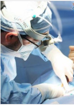 Dr. Suliburk operating with surgical loupes and headlight